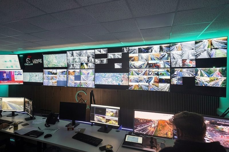 A control room featuring a large video wall displaying live highway CCTV feeds and traffic monitoring data.