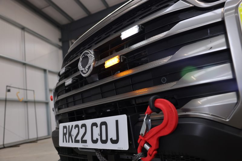 Close-up of a 4x4 traffic management vehicle featuring amber warning lights, winch and red recovery hook.