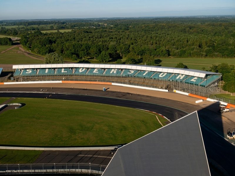 Drone view of the Silverstone Circuit grandstand and freshly laid asphalt on the race track surface.